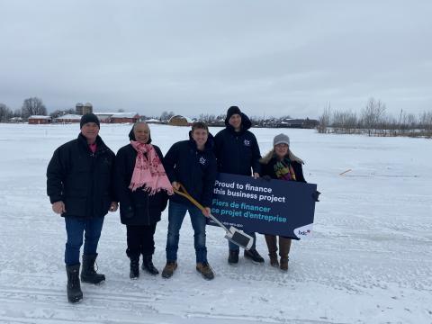 Five people in field for ground breaking