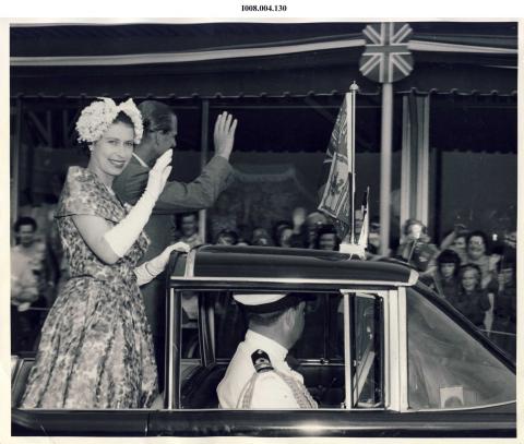 Queen 1959 riding in a car waving