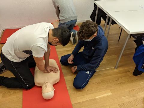 People on floor doing CPR